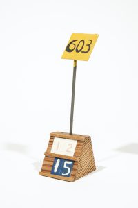 Small two tier horizontal wooden block with metal flag