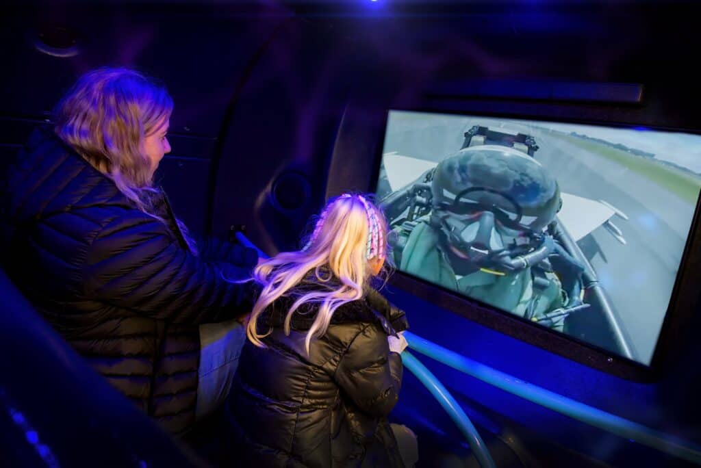 2 people inside a flight simulator
