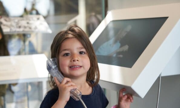 child listening to exhibition information