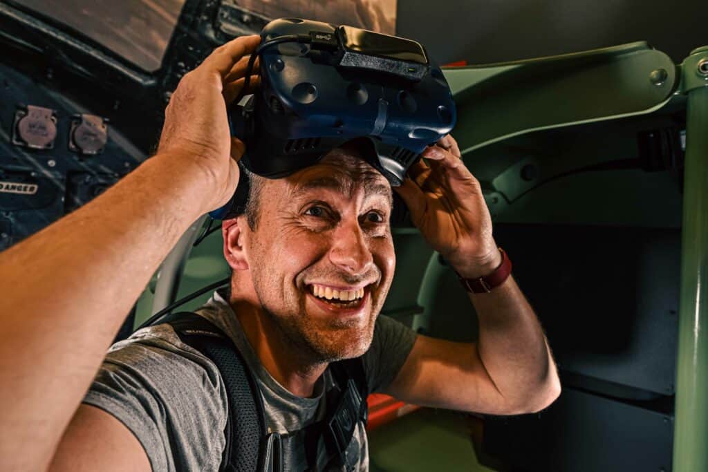 A man looks ecstatic as he takes the headset off