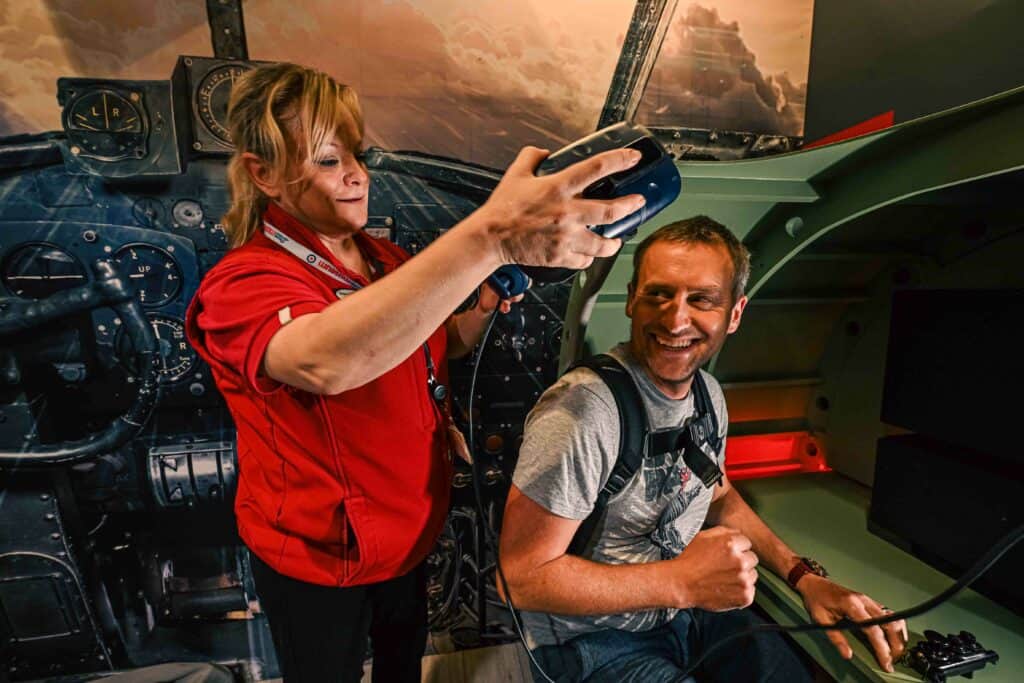 A member of staff places the headset on a visitor