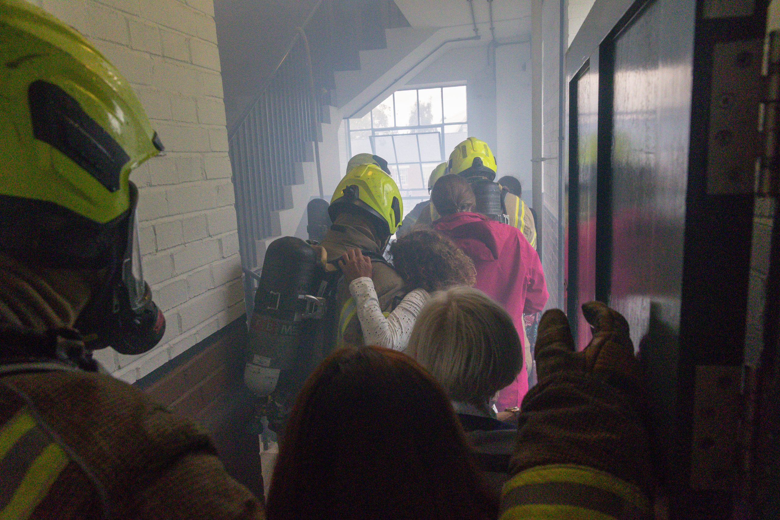 London Fire Brigade Firemen evacuating exercise volunteers from Hangar 2