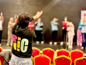 A person standing in front of a group of people