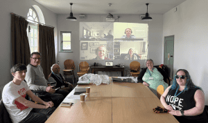 A photo of some of the Access Advisory Group Members at a meeting. Attending both in person at the Museum and online.