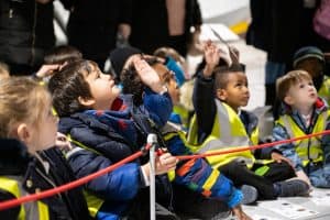 Small children putting hand up