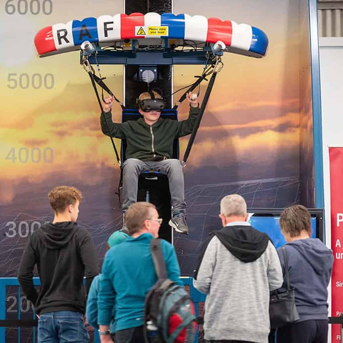 A young man playing the VR simulator of Paragliding