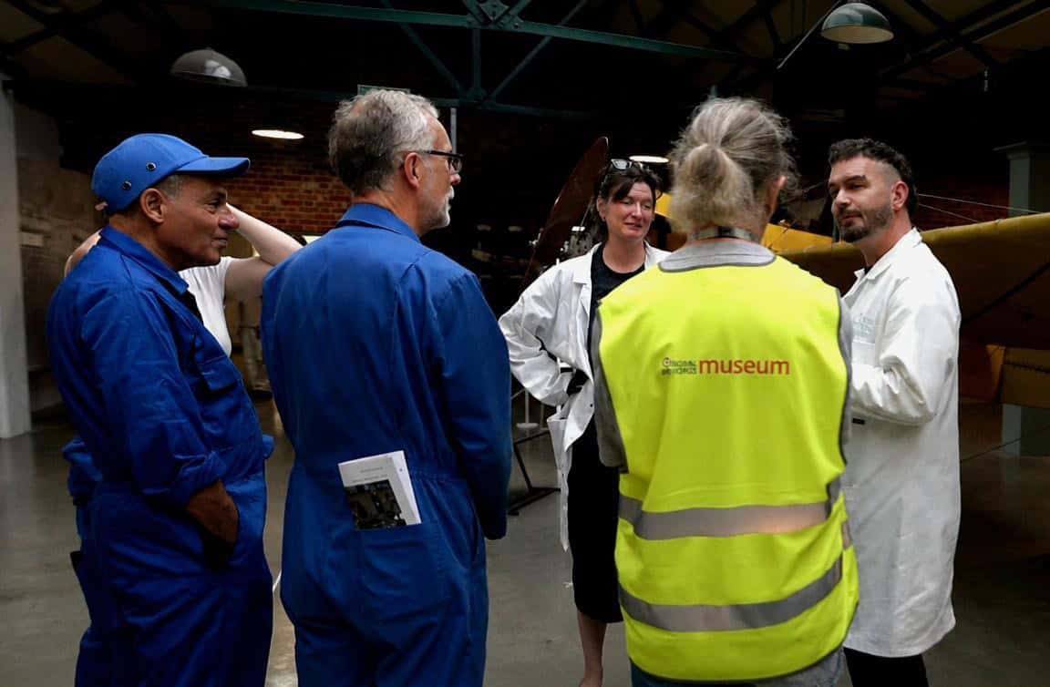 Figure 3, On-site conservation consultation between Amy Seadon, Peter Zetye and volunteers, discussing treatment options for a historic aircraft. Image credit: Robert Wright, Content Producer RAFM