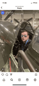 A screenshot from an Instagram post showing a young man in the cockpit of a Spitfire