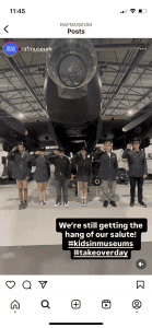 A screenshot from an Instagram post showing a group of young people saluting in front of a Lancaster bomber.