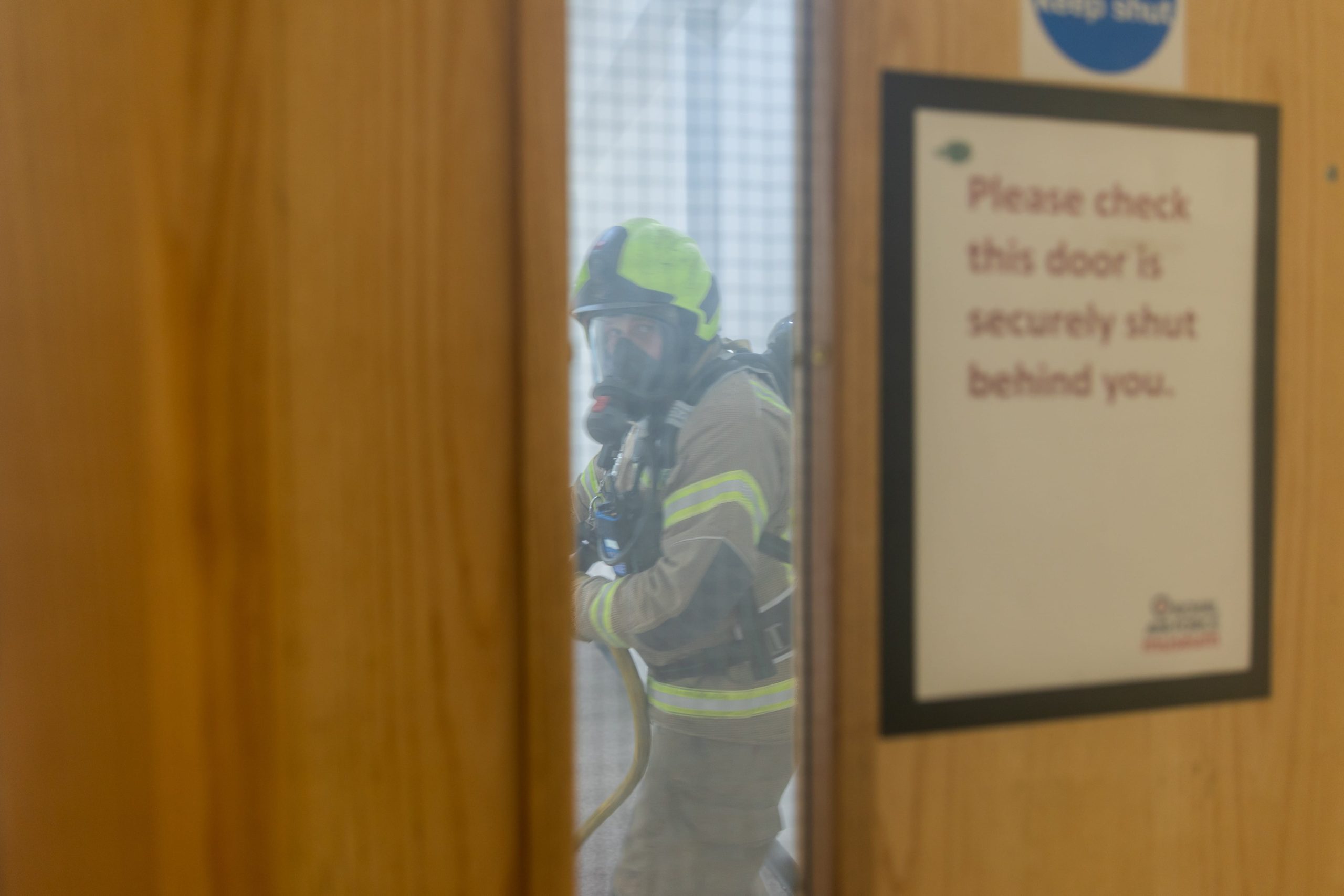 Members of London Fire Brigade in a smoke filled corridor