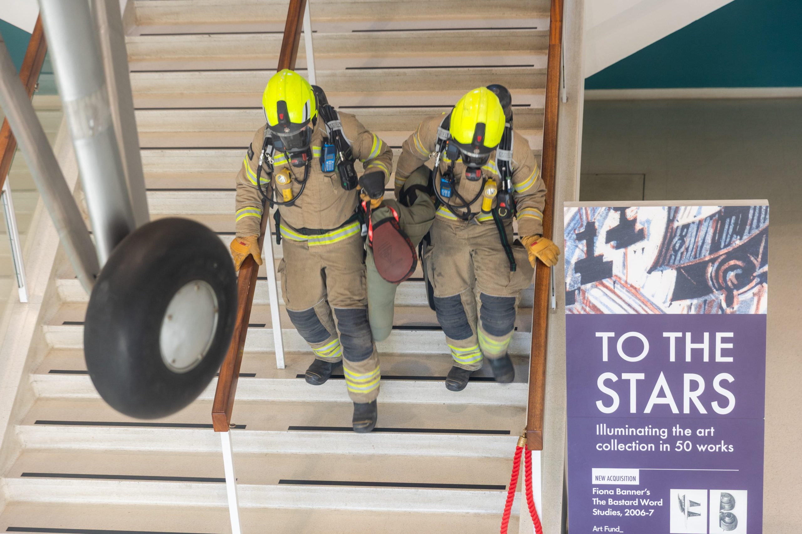 One of the casualties being carried by members of the London Fire Brigade out of Hangars 3,4,5