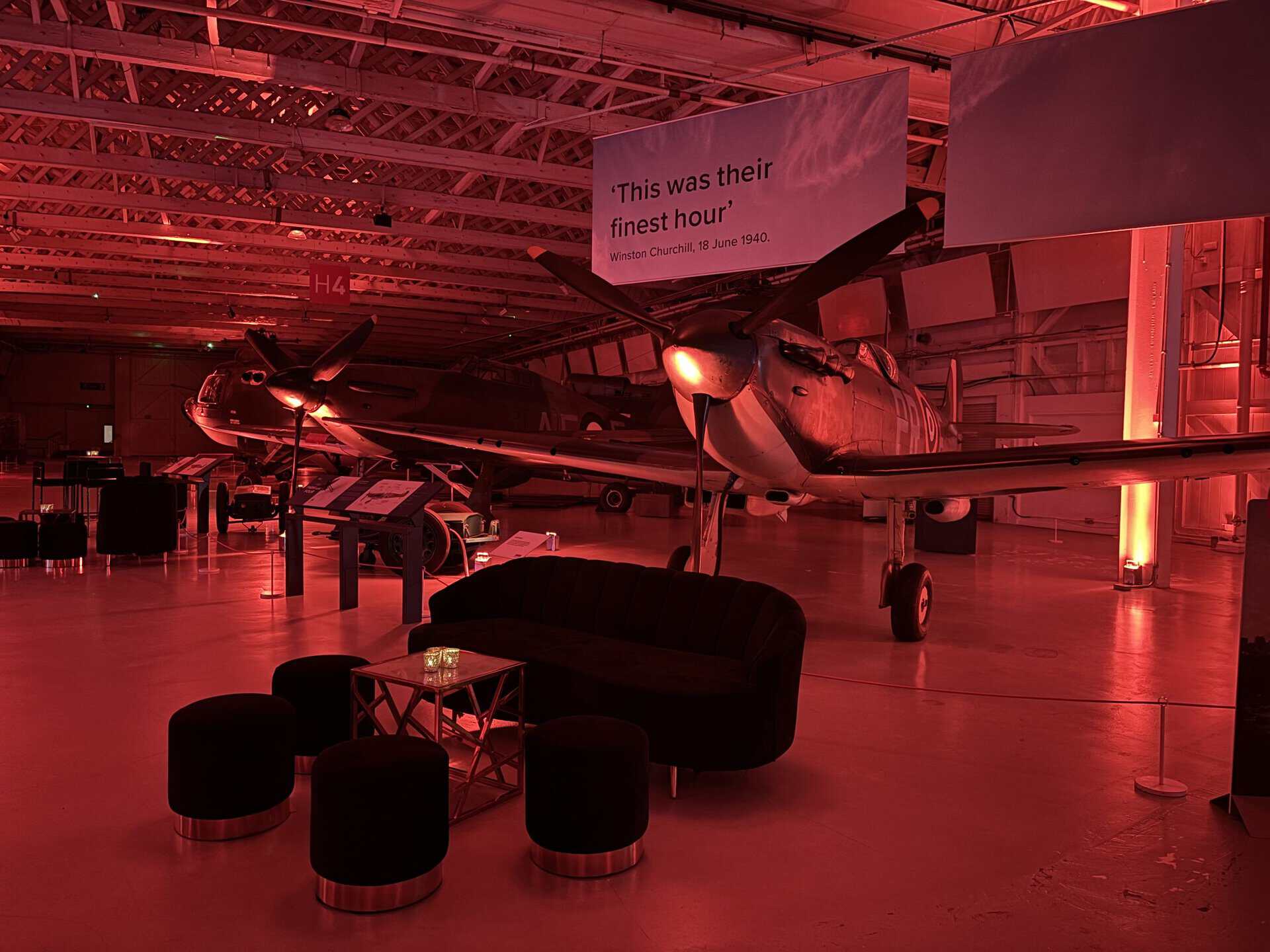 Hangar 3 and 4 lit with red light for an event in front of the Hurricane